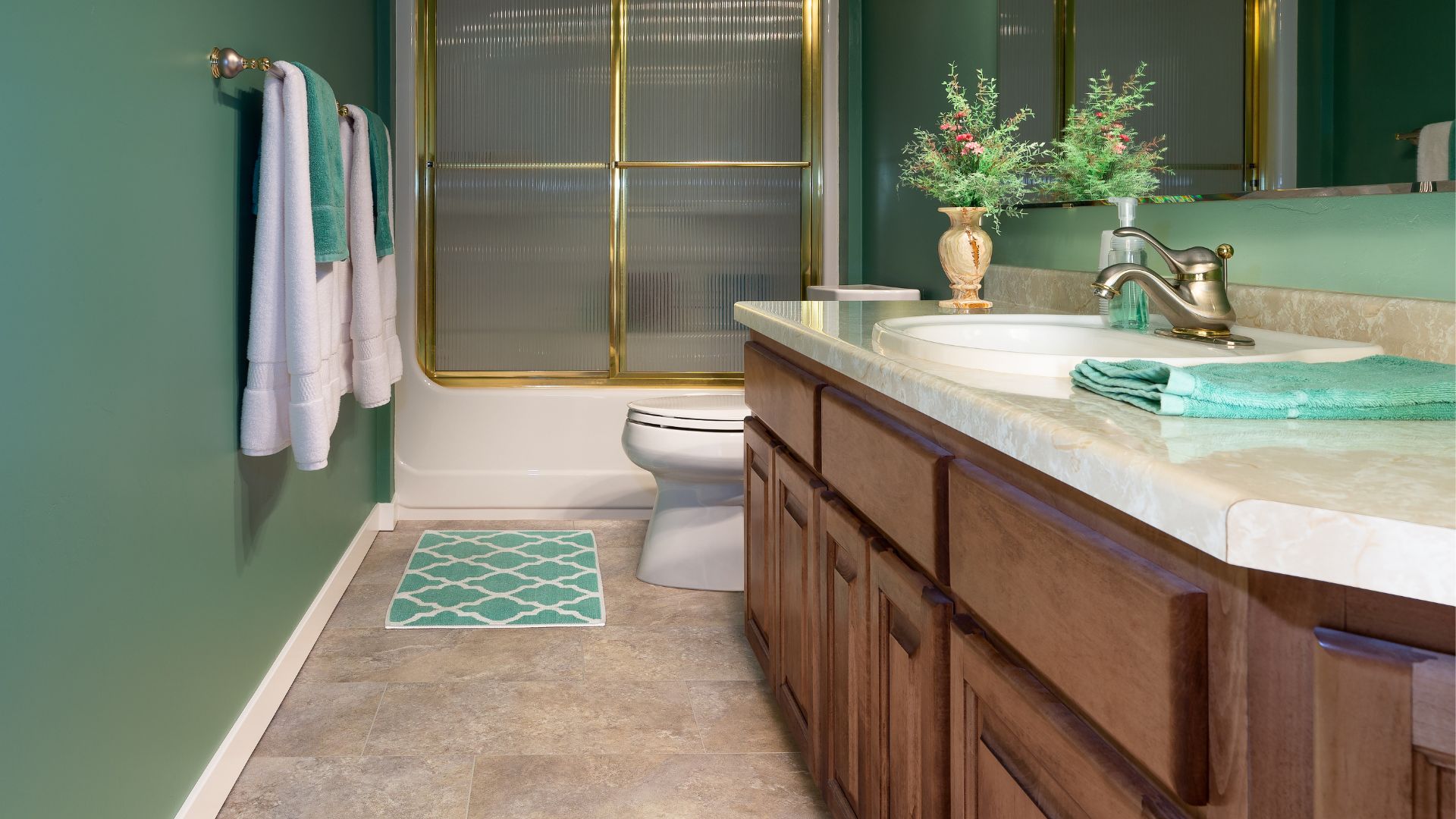 Green bathroom with brown vanity and toilet