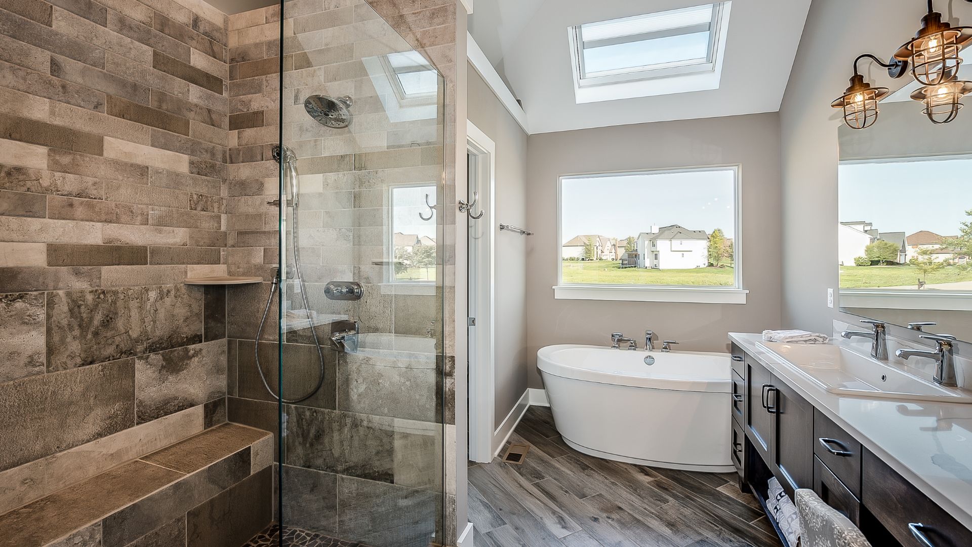 Elegant bathroom with walk-in shower, tub, and vanity