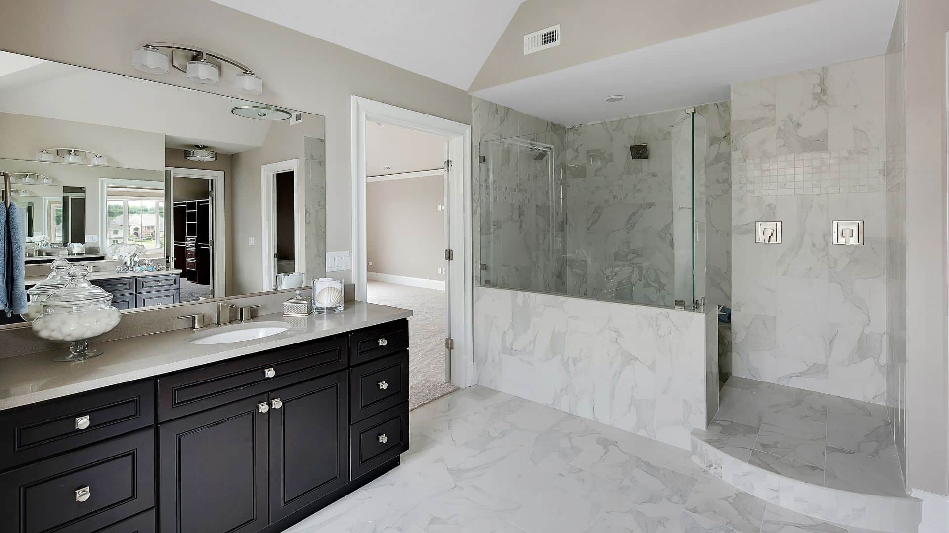Elegant bathroom with black vanity, and shower