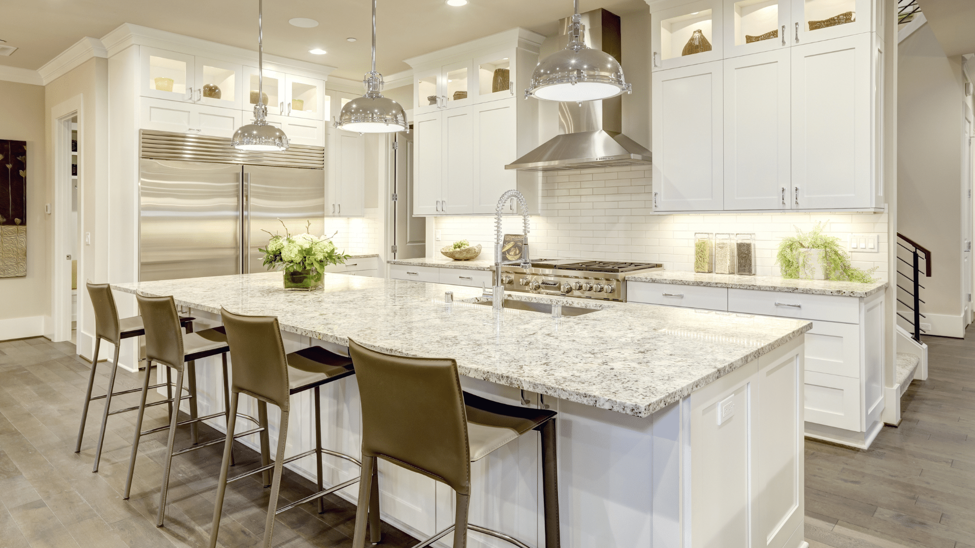 Luxury kitchen with white shaker cabinets and granite countertop