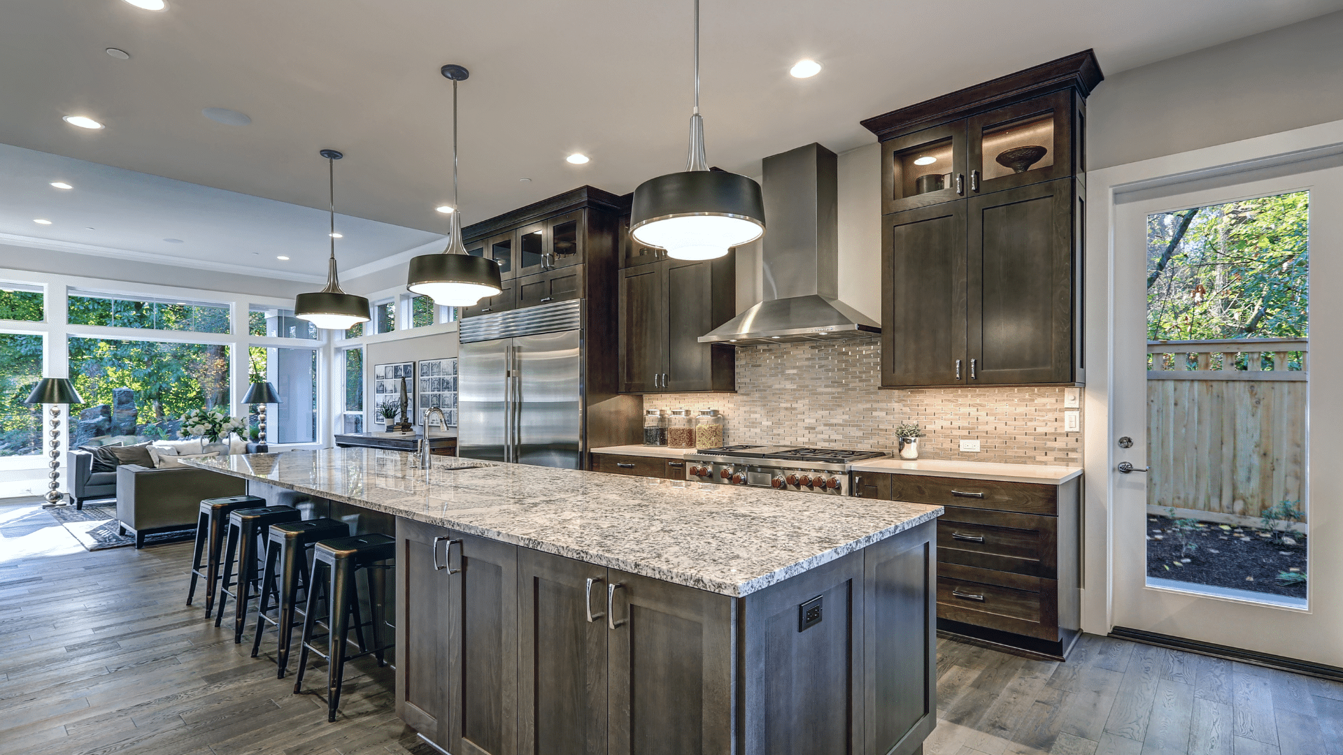 Spacious open-concept kitchen with grey shaker cabinets and granite countertop