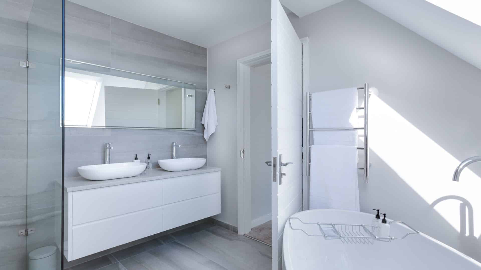 Elegant white bathroom with floating vanity, and tub