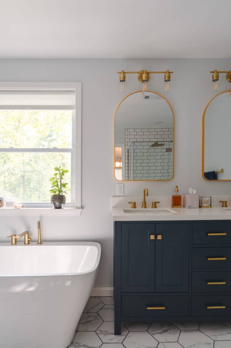 White Bathroom Remodeling Project in Stafford VA with navy vanity, tub, and textured flooring