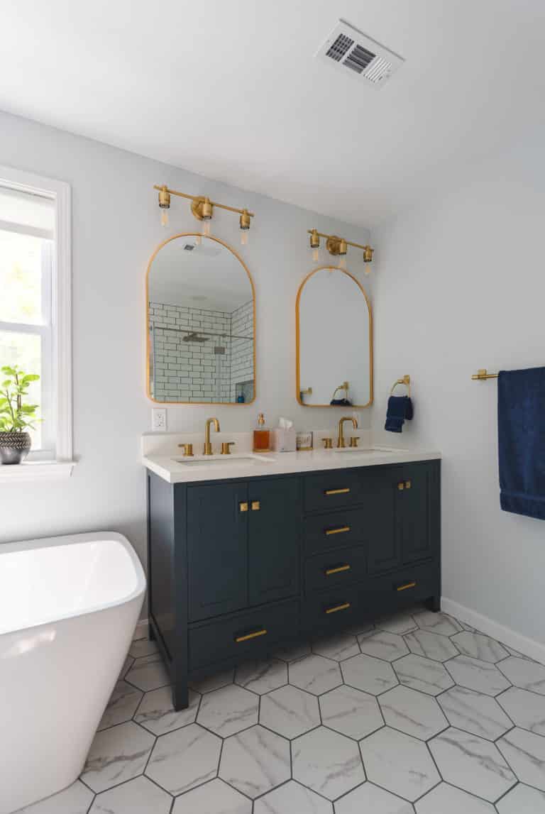 White Bathroom Remodeling Project in Stafford VA with navy vanity, tub, and textured flooring