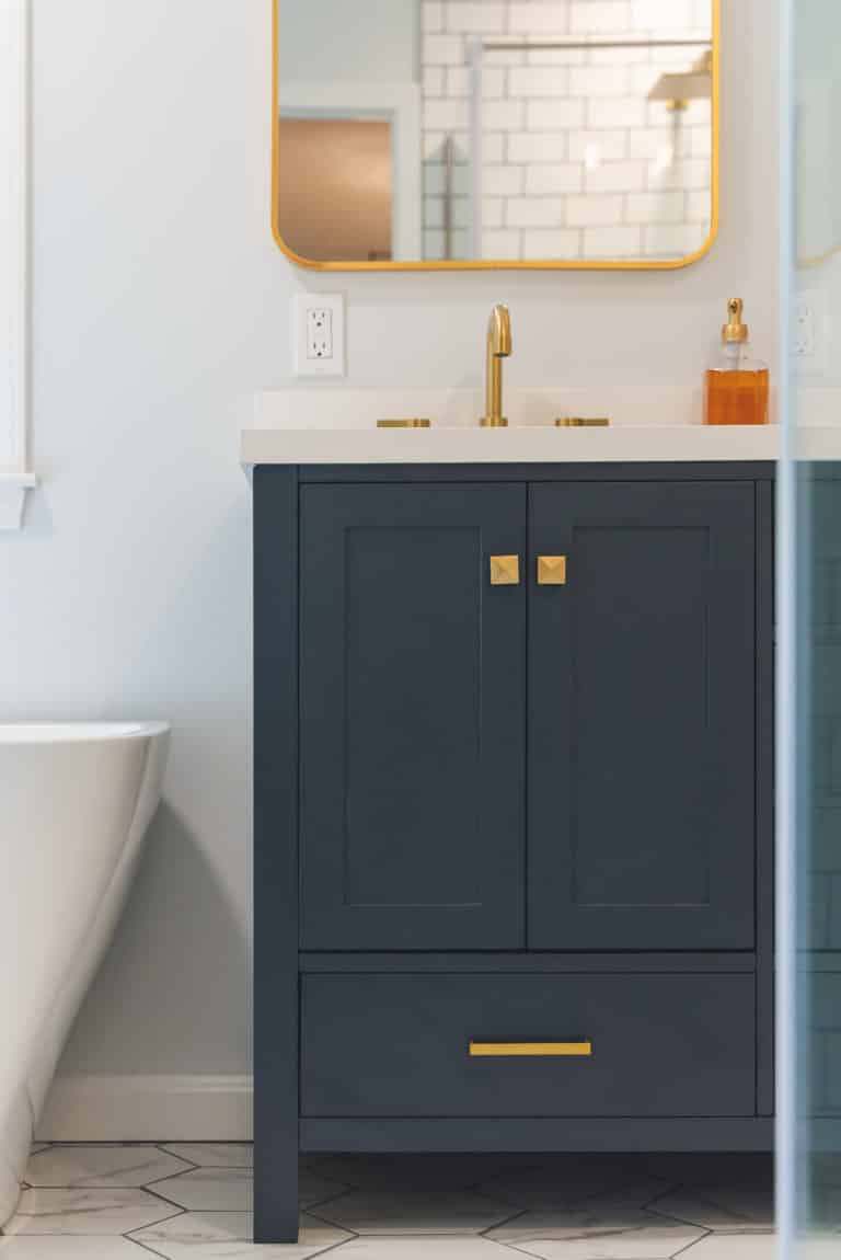 White Bathroom Remodeling Project in Stafford VA with navy vanity, tub, and textured flooring