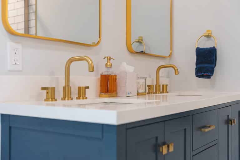 Navy vanity with gold faucets