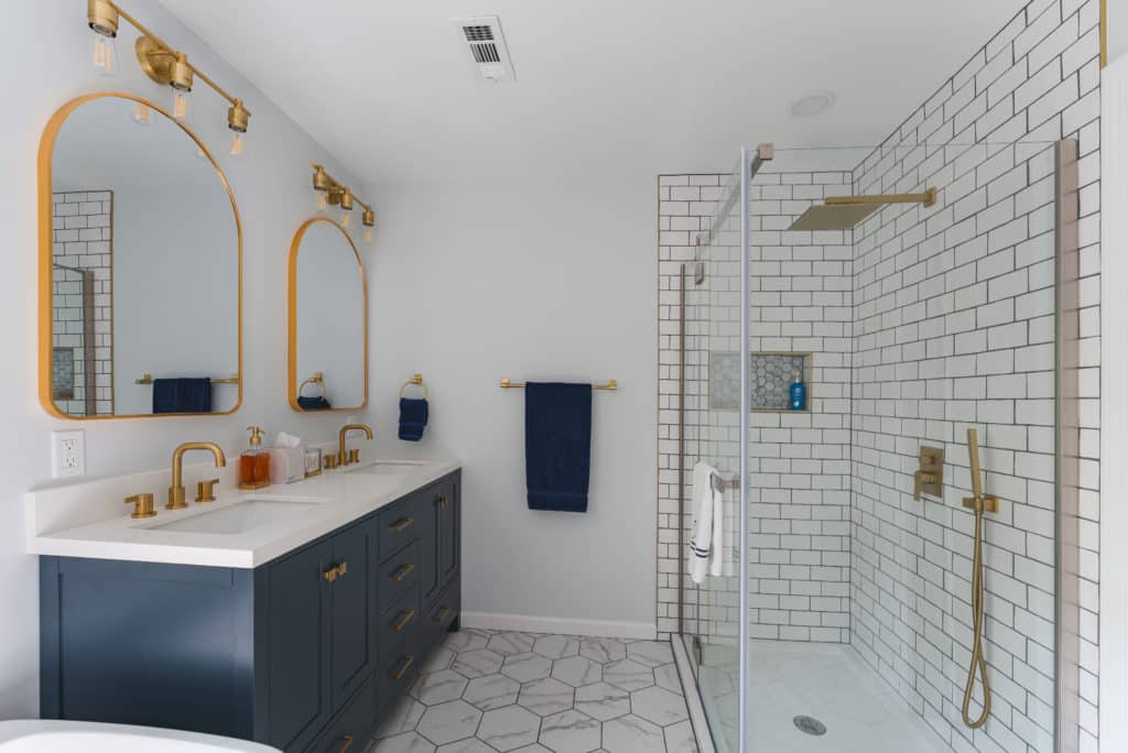 White Bathroom Remodeling Project in Stafford VA with navy vanity, walk-in shower, and textured flooring