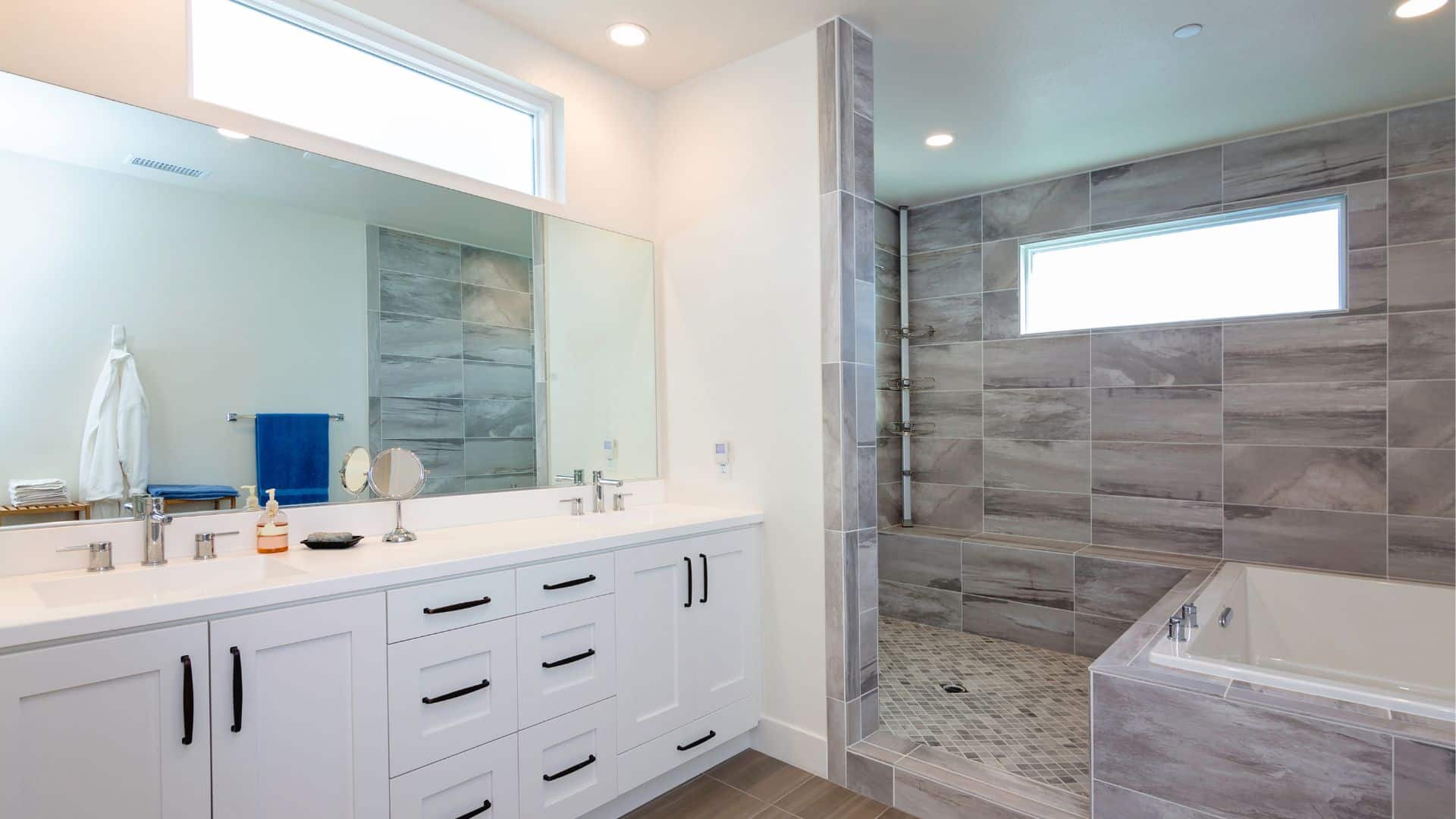 Elegant bathroom design with white shaker vanity, tub and shower
