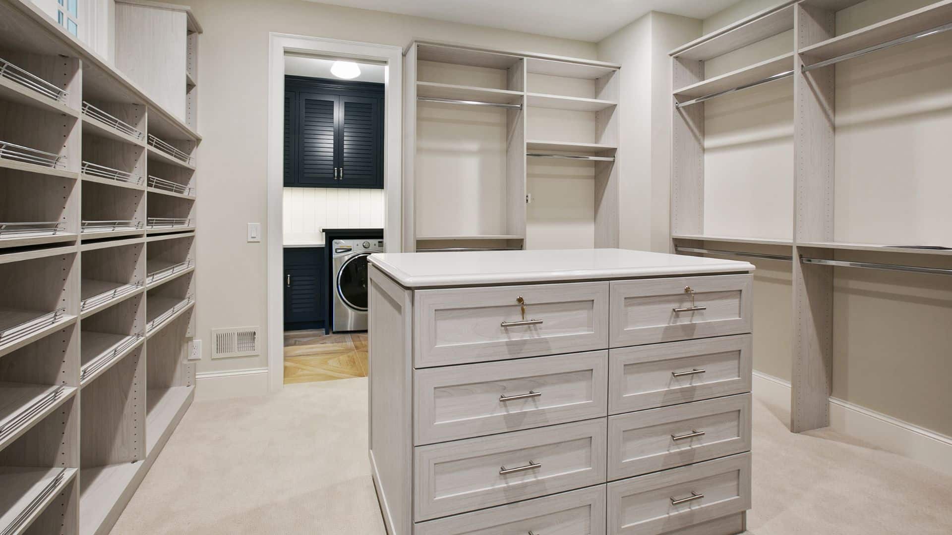 Custom closet design with center island with white countertop