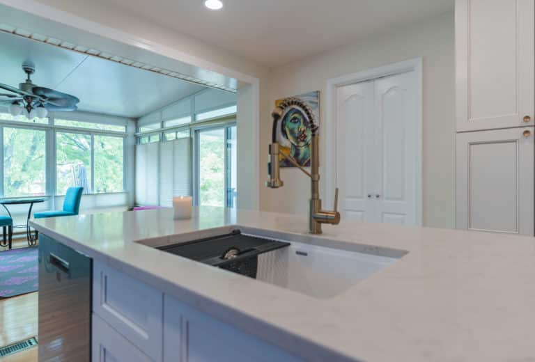 White countertop, sink, and faucet