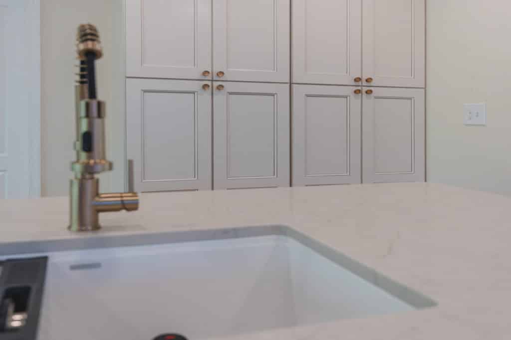 Faucet and sink on white kitchen island