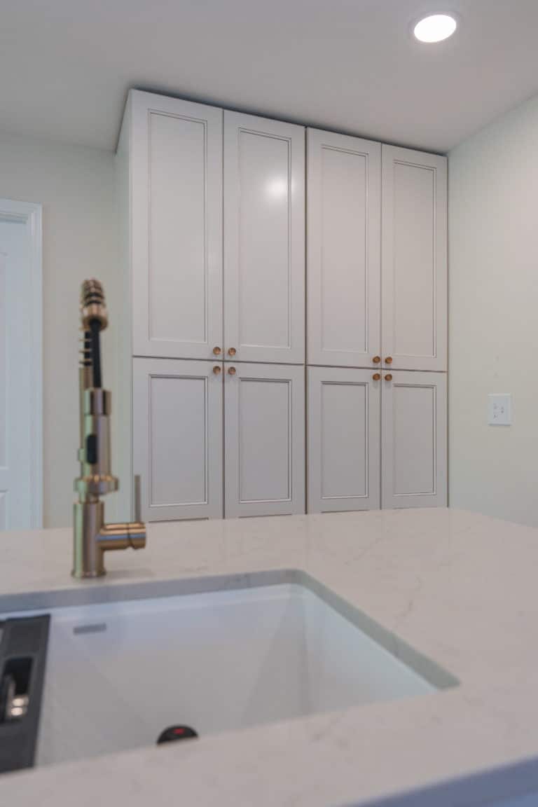 Elegant kitchen with white countertop and white cabinets