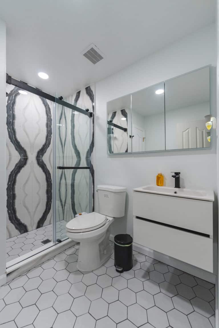 Bathroom with floating vanity, toilet, and shower