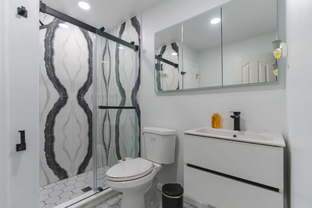 White floating vanity, toilet, and shower