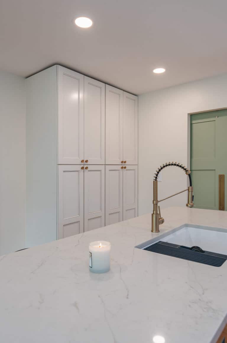 Elegant kitchen with white countertop and white cabinets