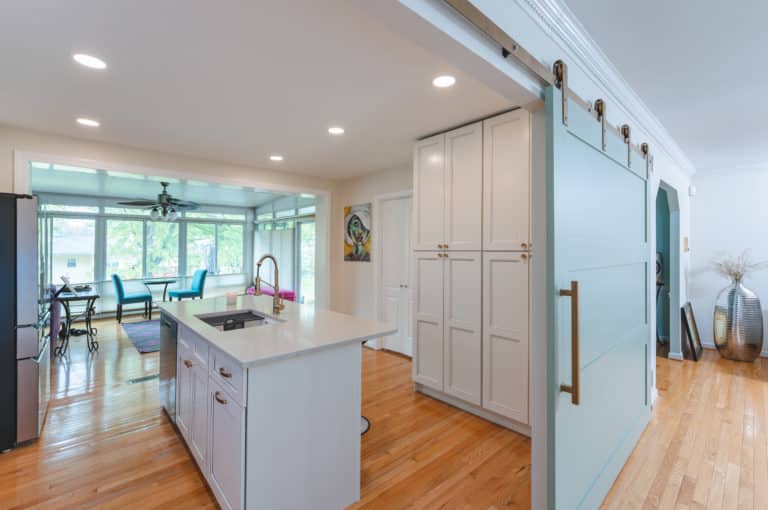 Open concept kitchen with white cabinets