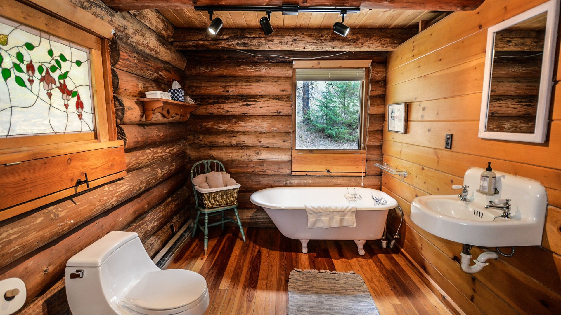Farmhouse bathroom style with tub, sink, and toilet