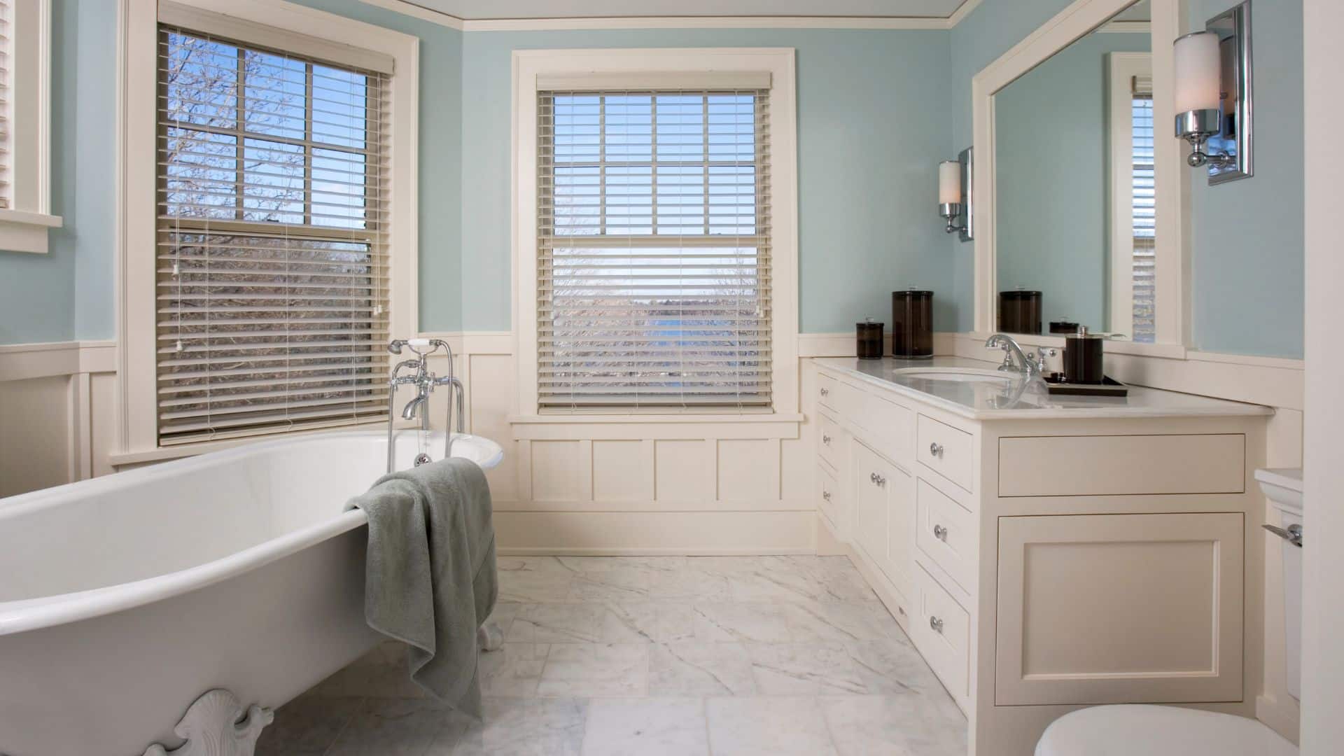 Elegant bathroom design with shaker vanity, tub and toilet
