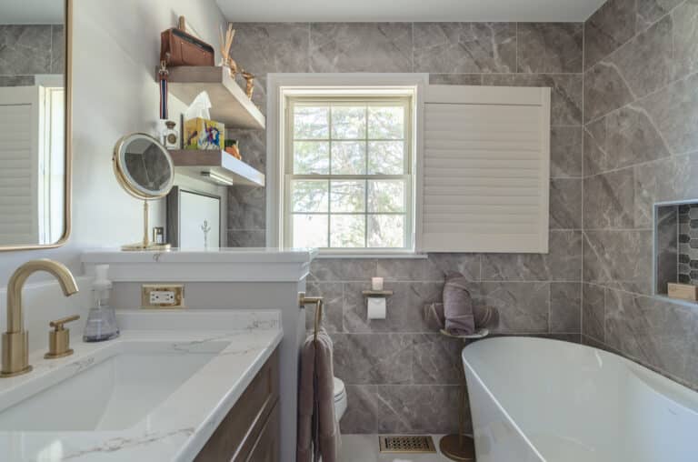 Bathroom with brown cabinets and tub