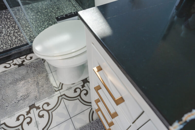 Bathroom Remodel In Nokesville, VA white cabinet with gold handles, and toilet