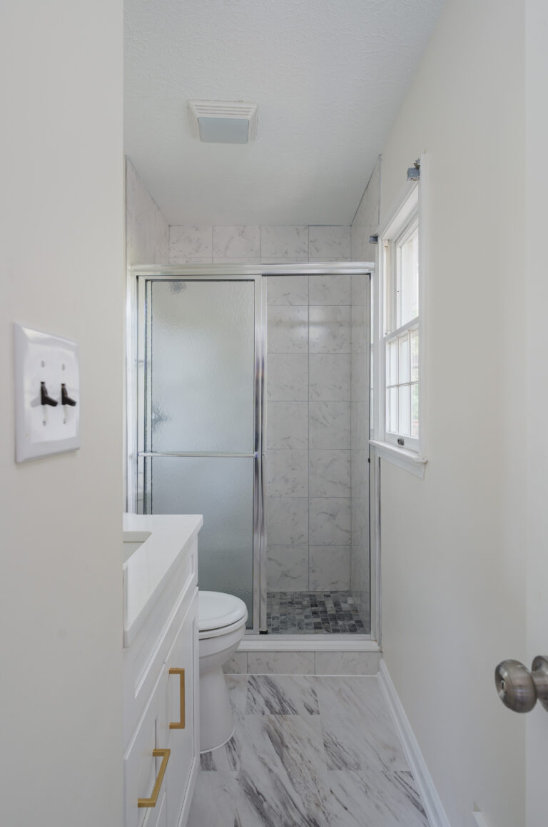 Sleek Bathroom Remodel in Nokesville VA with white vanity, shower and toilet