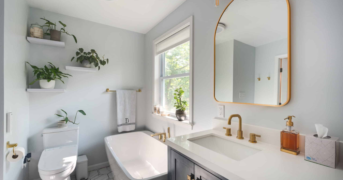 Elegant bathroom style with tub, vanity, and toilet