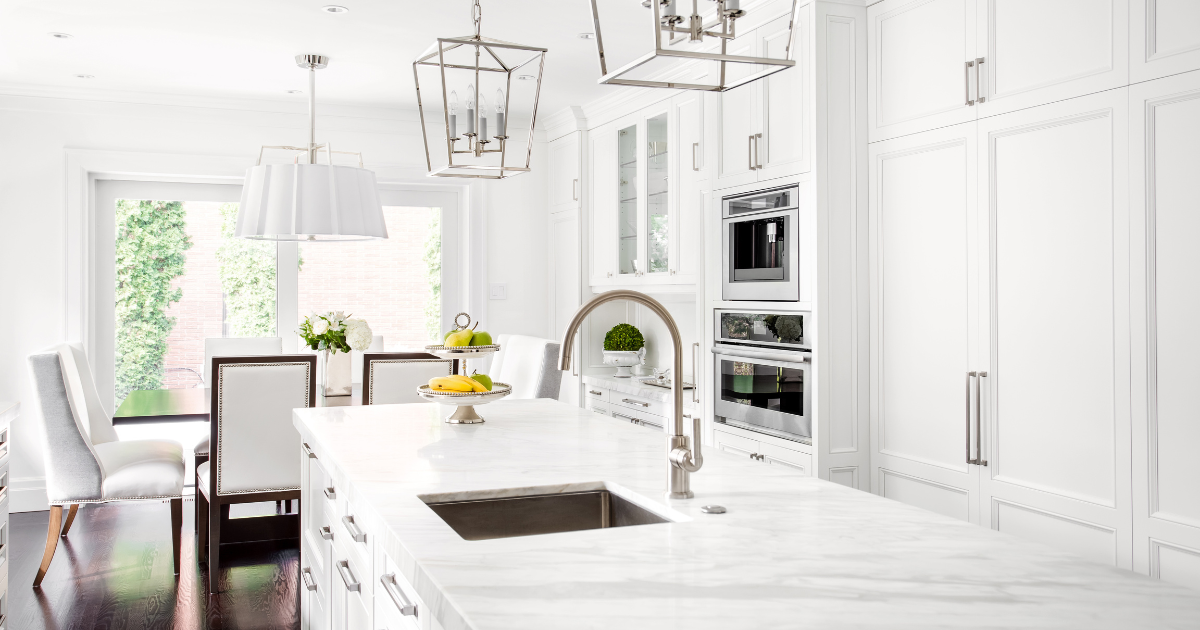 Bright white kitchen with white shaker cabinets and white countertops