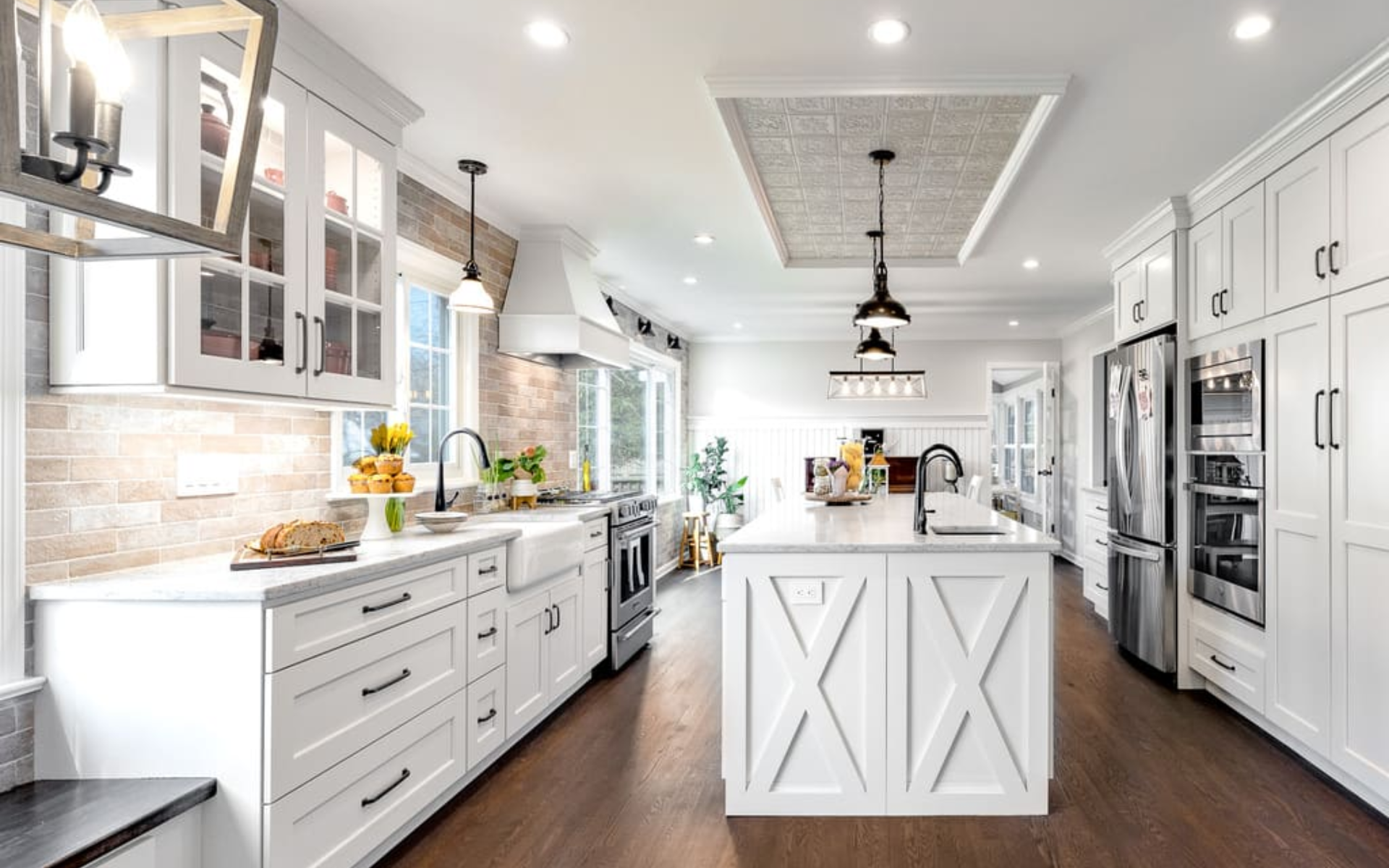 Elegant white kitchen with shaker cabinets and dark wood flooring