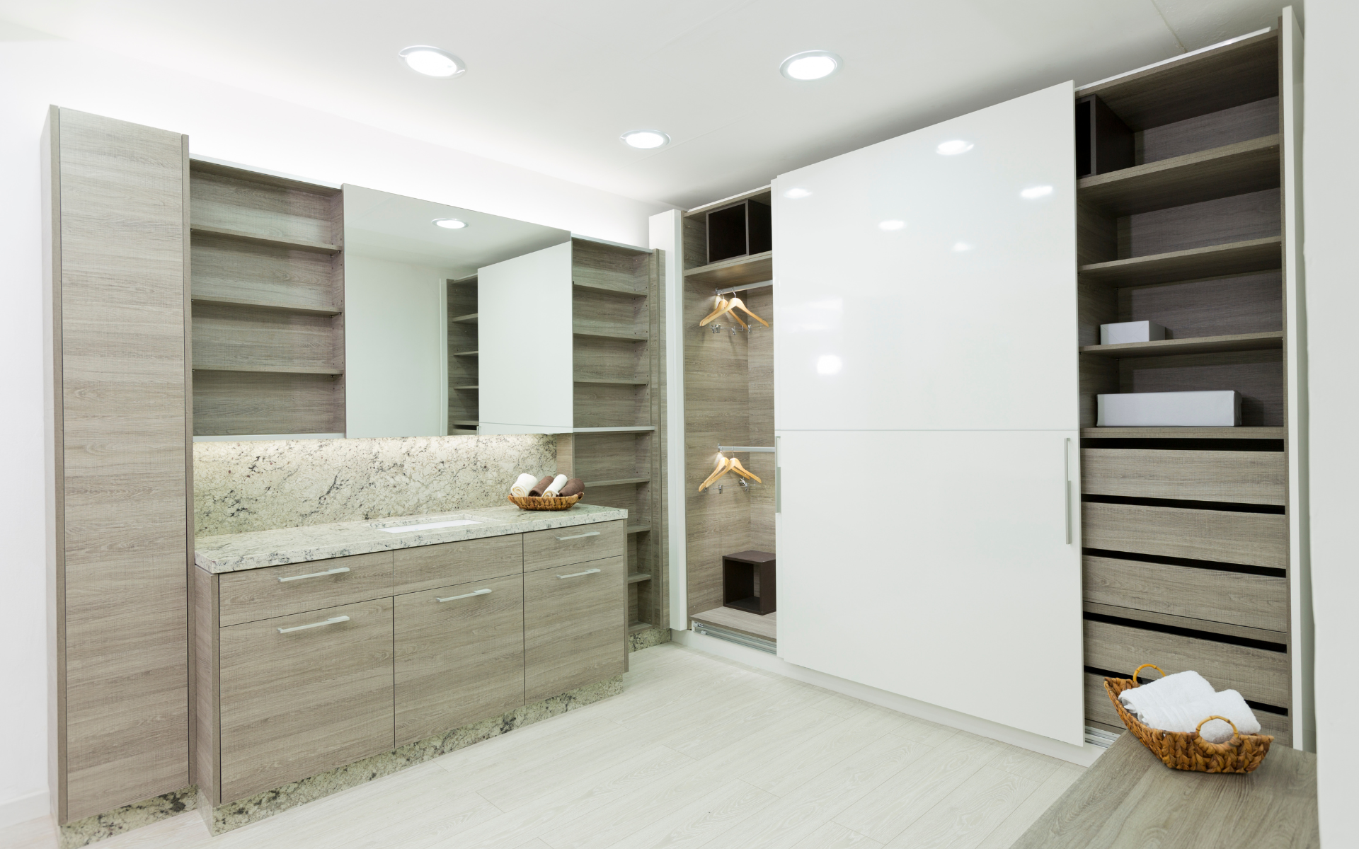 L type closet design with brown cabinet drawers, and white sliding closet door