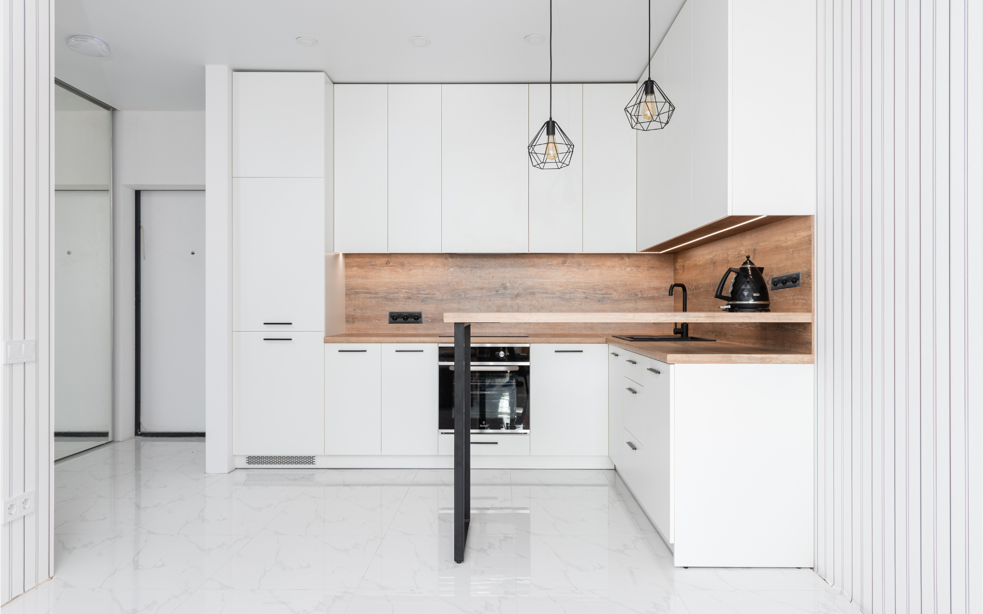 White kitchen cabinets with wood backsplash